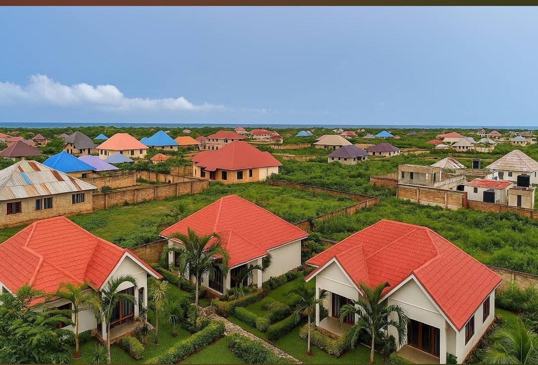 The red-roofed cottages among palm trees